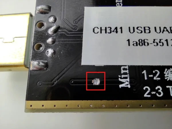Close-up of the back of the board near the USB connector, with the cut trace highlighted