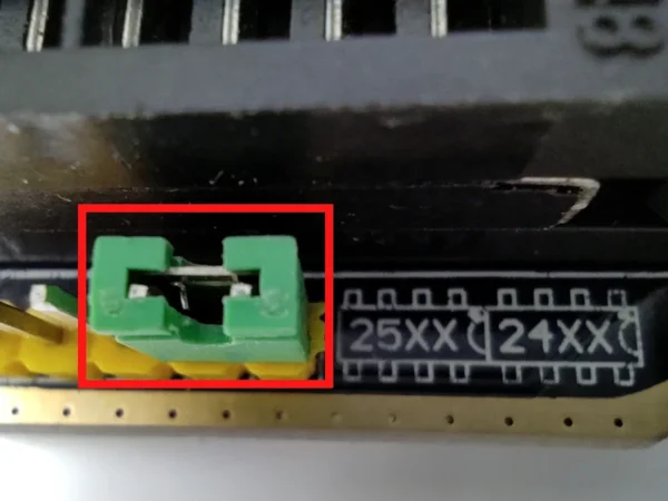 Close-up near the ZIF socket, with a small green 2-pin jumper block highlighted
